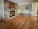 Spacious basement features brick fireplace with mantel, wood floors, and a window for natural light at 9236 W Euclid Ave, Littleton, CO 80123