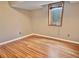 Finished basement area with natural light, wood-look floors, and neutral paint at 9236 W Euclid Ave, Littleton, CO 80123