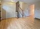 Inviting entryway features hardwood floors, a coat closet, and a staircase with white railings at 9236 W Euclid Ave, Littleton, CO 80123