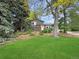 Charming two-story home with a well-maintained lawn and mature trees at 9236 W Euclid Ave, Littleton, CO 80123