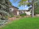 Charming two-story home with a lush green lawn and mature trees at 9236 W Euclid Ave, Littleton, CO 80123