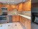Bright kitchen featuring stainless steel appliances and oak cabinets at 9236 W Euclid Ave, Littleton, CO 80123