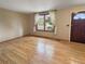 Bright living room features hardwood floors, a window with neighborhood views, and a neutral color palette at 9236 W Euclid Ave, Littleton, CO 80123