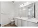Modern bathroom with dual sinks, sleek white cabinets, and a large mirror at 6974 E 126Th Dr, Thornton, CO 80602