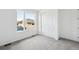 Cozy bedroom featuring neutral carpet, a large window, and a convenient closet at 6974 E 126Th Dr, Thornton, CO 80602
