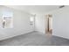 Bright bedroom featuring neutral carpet, a window, and entry to another room at 6974 E 126Th Dr, Thornton, CO 80602