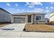 Charming single-story home featuring stone accents, a two-car garage, and a well-lit entrance at 6974 E 126Th Dr, Thornton, CO 80602
