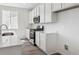 Bright, modern kitchen features white cabinets, stainless steel appliances, and sleek countertops at 6974 E 126Th Dr, Thornton, CO 80602