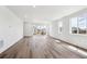 Spacious living area with modern wood floors, recessed lighting, and access to the backyard at 6974 E 126Th Dr, Thornton, CO 80602