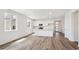 Open-concept living space featuring a modern kitchen with an island and ample natural light at 6974 E 126Th Dr, Thornton, CO 80602