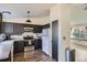 Stylish kitchen with modern appliances, sleek countertops, and an adjoining view to living area at 8370 Sandreed Cir, Parker, CO 80134