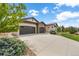 Front view of home showcasing stone accents and a two-car garage at 2434 Marshall Ct, Erie, CO 80516