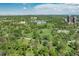 An aerial view showcases the lush green landscape and tranquil lake surrounding the property in Denver, Colorado at 1642 N Lafayette St # 5, Denver, CO 80218