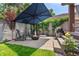 Private backyard oasis with a patio, fire pit, grill, and mature landscaping at 350 Holly St, Denver, CO 80220