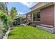 Expansive backyard with lush green lawn, a cozy patio area, and mature trees for shade and privacy at 350 Holly St, Denver, CO 80220
