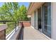 Outdoor balcony features brick details and views of mature green trees at 350 Holly St, Denver, CO 80220