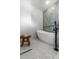 Luxurious bathroom with freestanding tub, modern fixtures, and sleek herringbone tile at 350 Holly St, Denver, CO 80220
