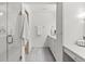 Bright, modern bathroom features a glass-enclosed shower and vanity with storage at 350 Holly St, Denver, CO 80220