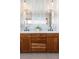 Bathroom vanity features dual sinks, designer mirrors, and modern lighting fixtures at 350 Holly St, Denver, CO 80220