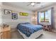 Cozy bedroom with striped walls, ample natural light, and unique decor at 350 Holly St, Denver, CO 80220