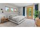 Bright bedroom with large windows, plush carpet, and a balcony with a verdant view at 350 Holly St, Denver, CO 80220