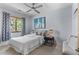 Bright bedroom with a ceiling fan, large window with view, and modern art piece at 350 Holly St, Denver, CO 80220