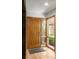 Bright front foyer with decorative wood door and window and a glimpse of the green outdoors at 350 Holly St, Denver, CO 80220