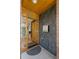 Open front foyer with stylish tile wall, wood door, and views into the home's living spaces at 350 Holly St, Denver, CO 80220