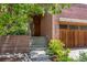 Inviting front entrance with brick facade, manicured landscaping and steps leading to the front door at 350 Holly St, Denver, CO 80220