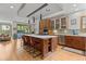 Gourmet kitchen features a large island with seating, stainless steel appliances and custom cabinets at 350 Holly St, Denver, CO 80220