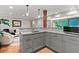 Modern kitchen with grey cabinetry, granite countertops, stainless steel microwave at 350 Holly St, Denver, CO 80220