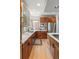 Modern kitchen featuring stainless steel appliances, wooden cabinetry, white countertops, and stylish backsplash at 350 Holly St, Denver, CO 80220