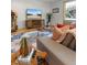 Cozy living room featuring a vintage jukebox, entertainment center, and comfortable seating area at 350 Holly St, Denver, CO 80220