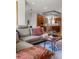 Open-concept living room showcasing modern furnishings, a stylish coffee table, and hardwood floors at 350 Holly St, Denver, CO 80220