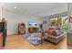 Bright living room features vintage jukebox, neutral decor, and view of dining and kitchen at 350 Holly St, Denver, CO 80220