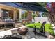 Outdoor patio with a built-in grill, fire pit, and a large umbrella for comfortable and stylish outdoor living at 350 Holly St, Denver, CO 80220