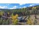 Aerial view capturing the home's exterior and surroundings, set against a mountain backdrop at 779 Aspen Way, Evergreen, CO 80439