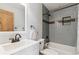 Bathroom featuring a shower, updated vanity, toilet, and a wooden door at 779 Aspen Way, Evergreen, CO 80439