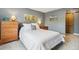 Bedroom featuring gray walls, a wooden sliding door, and a bed with white linens and decorative pillows at 779 Aspen Way, Evergreen, CO 80439