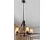 Modern industrial-style chandelier with Edison bulbs, adding a touch of rustic charm to the room at 779 Aspen Way, Evergreen, CO 80439