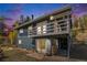 Charming home with a spacious deck and a cozy area to store wood, all surrounded by lush greenery at 779 Aspen Way, Evergreen, CO 80439