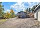 Charming exterior of home featuring a spacious yard, deck, and a serene natural setting at 779 Aspen Way, Evergreen, CO 80439