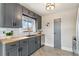 Well-lit kitchen featuring gray cabinets, butcher block countertops, stainless steel appliances, and subway tile backsplash at 779 Aspen Way, Evergreen, CO 80439