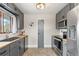 Well-lit kitchen featuring gray cabinets, butcher block countertops, stainless steel appliances, and subway tile backsplash at 779 Aspen Way, Evergreen, CO 80439