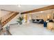 Living area features stairs to second floor, wood accents and comfortable blue sofas at 779 Aspen Way, Evergreen, CO 80439