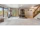 Cozy living room with stone fireplace, sliding door access to outdoor space and wooden staircase at 779 Aspen Way, Evergreen, CO 80439