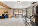 Open living room with wood beam ceiling, a stone fireplace and lots of natural light at 779 Aspen Way, Evergreen, CO 80439