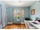 Bright home office space featuring a large window, hardwood floors, and neutral decor at 779 Aspen Way, Evergreen, CO 80439