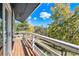 Wide angle of a wood deck with a white railing overlooking the surrounding forest and trees at 779 Aspen Way, Evergreen, CO 80439