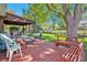 Relaxing covered patio with ample seating, a spacious deck, and a lush green backyard at 3270 S Krameria St, Denver, CO 80222